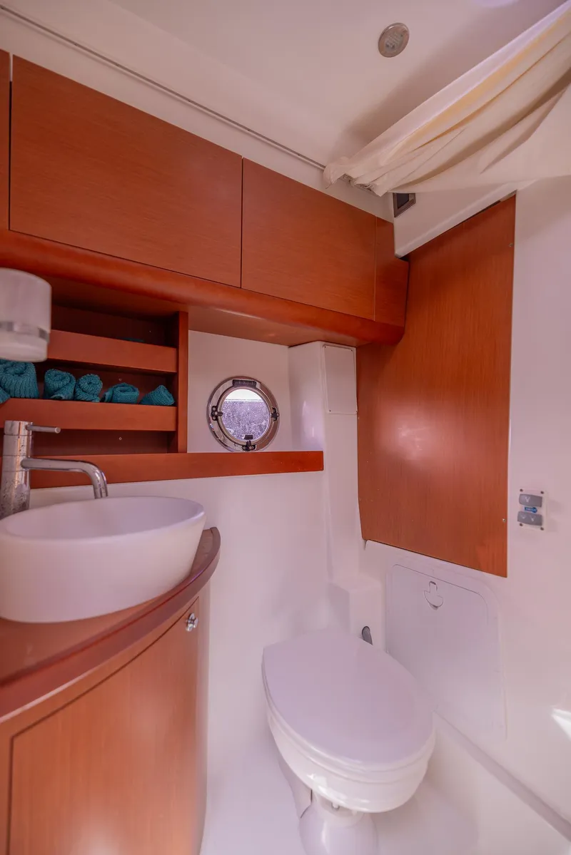 Slide: The Image of Luxurious bathroom in 2013 Beneteau GRAN TURISMO 38 yacht with modern fixtures and wood accents. - 31