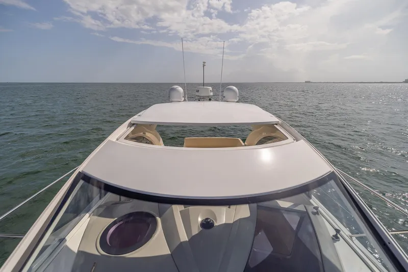 Slide: The Image of 2013 Beneteau Gran Turismo 38 yacht cruising on open water under a cloudy sky. - 14