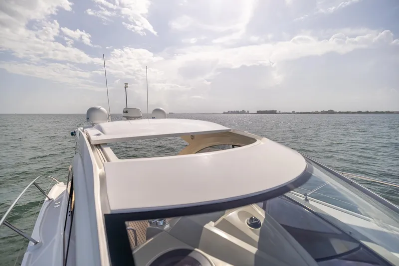 Slide: The Image of 2013 Beneteau Gran Turismo 38 yacht cruising on open water under a partly cloudy sky. - 13