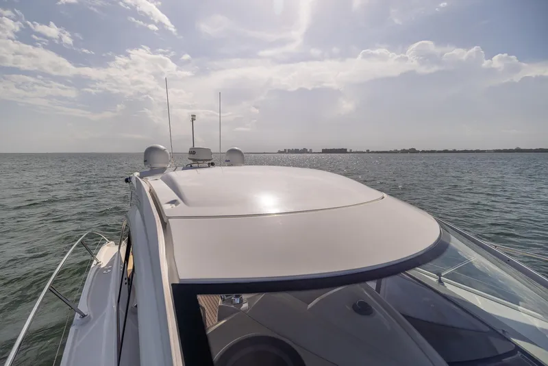 Slide: The Image of 2013 Beneteau GRAN TURISMO 38 yacht cruising on open water under a cloudy sky. - 17