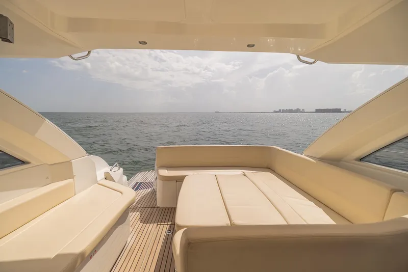 Slide: The Image of Luxury seating area on 2013 Beneteau Gran Turismo 38 yacht, overlooking serene ocean view. - 7