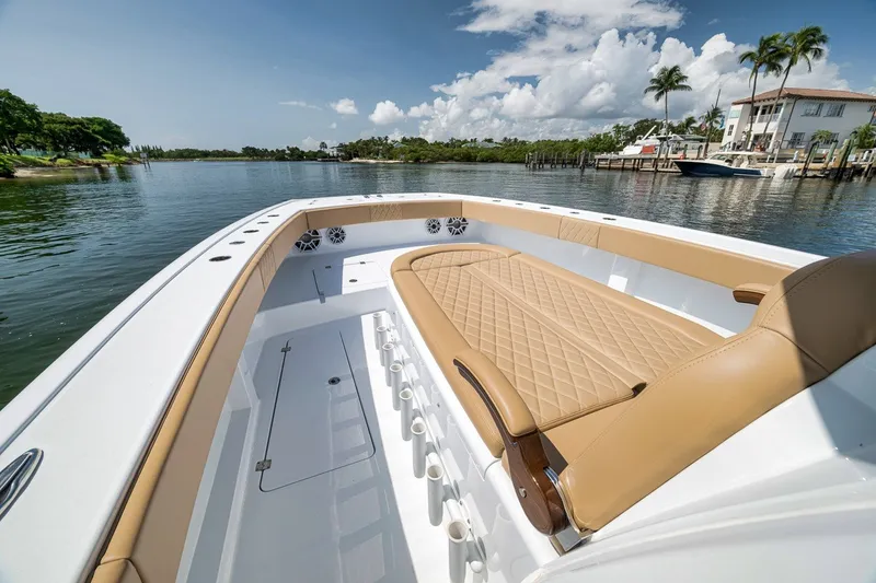 Slide: The Image of Luxurious 2026 Freeman 42LR boat interior with tan seating, docked by waterfront homes. - 45