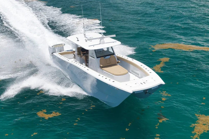 Slide: The Image of 2026 Freeman 42LR boat cruising on clear blue ocean waters. - 15