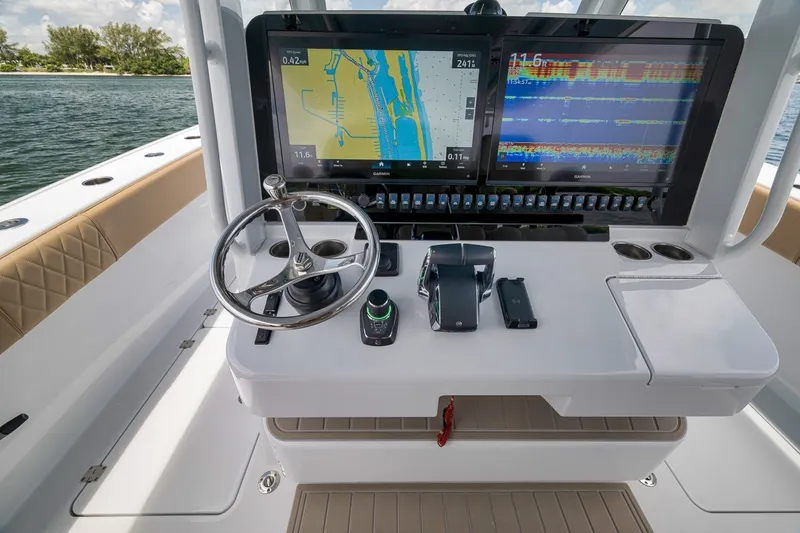 Slide: The Image of Freeman 42LR 2026 boat dashboard with dual navigation screens and steering wheel. - 113