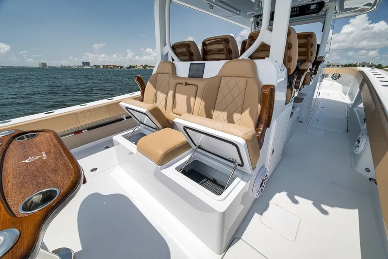 Slide: The Image of Luxurious 2026 Freeman 42LR boat interior with tan seating and open storage compartments. - 76