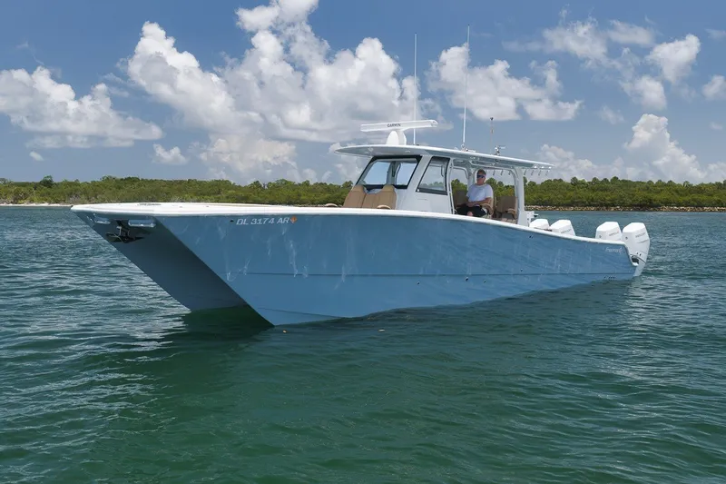 Slide: The Image of 2026 Freeman 42LR boat on water, clear sky, and lush shoreline in the background. - 32