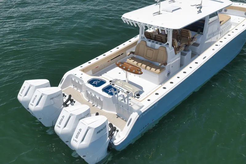 Slide: The Image of 2026 Freeman 42LR boat with quad Mercury engines on calm water. - 25