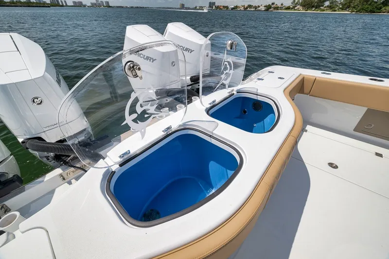 Slide: The Image of 2026 Freeman 42LR boat with dual livewells and Mercury outboard engines on a sunny day. - 63
