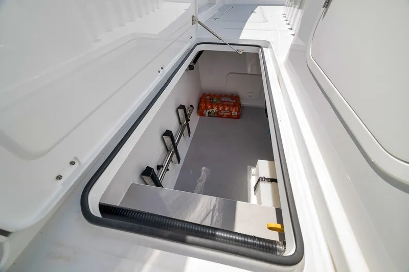 Slide: The Image of Storage compartment in 2026 Freeman 42LR boat, featuring organized beverage storage. - 53