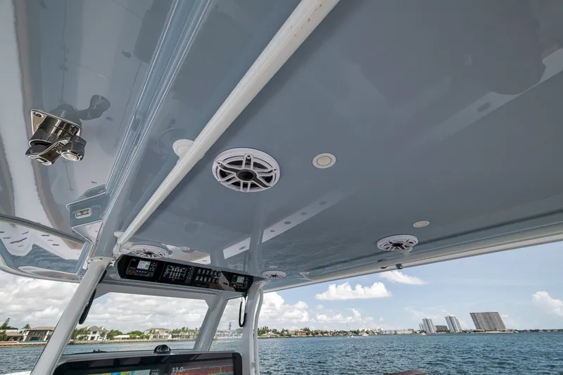 Slide: The Image of Interior view of 2026 Freeman 42LR boat with speakers and ocean backdrop. - 97