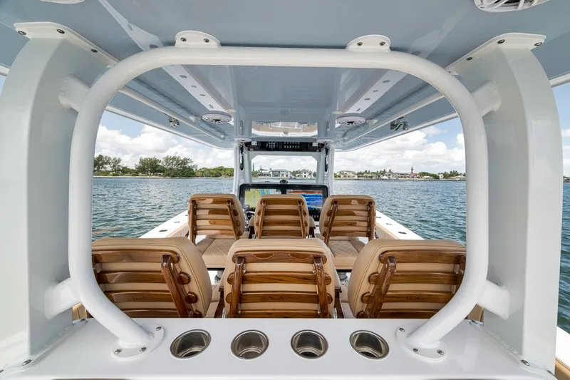 Slide: The Image of Interior view of 2026 Freeman 42LR boat with wooden seating and ocean backdrop. - 91