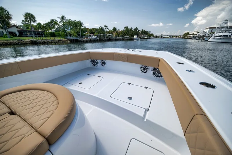 Slide: The Image of Luxurious 2026 Freeman 42LR boat interior with tan seating, docked by a scenic waterfront. - 39