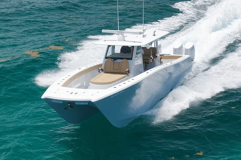 Slide: The Image of 2026 Freeman 42LR boat cruising on clear blue ocean waters. - 16