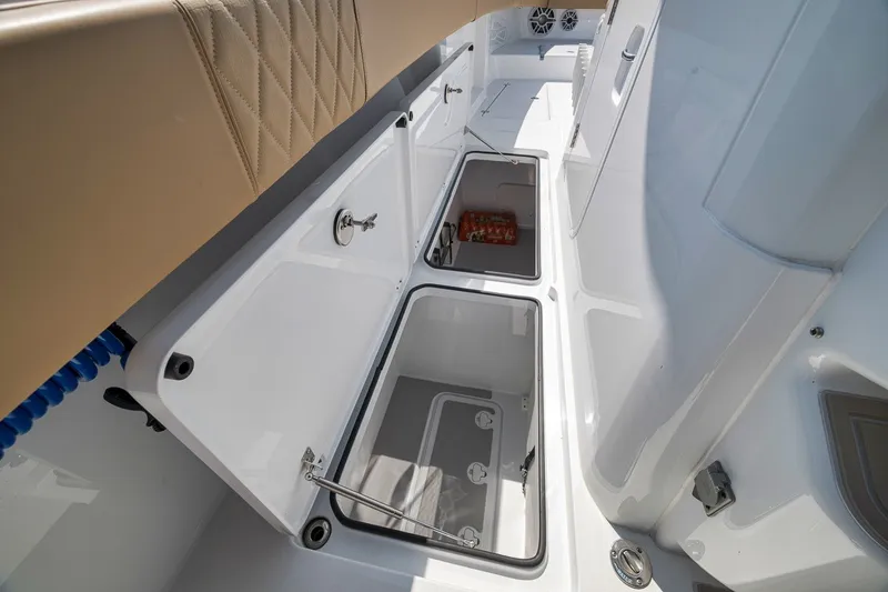 Slide: The Image of Open storage compartments on a 2026 Freeman 42LR boat deck. - 52