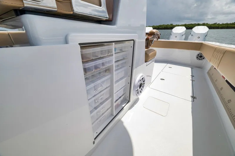 Slide: The Image of Freeman 42LR 2026 boat interior with storage compartments and seating area. - 80