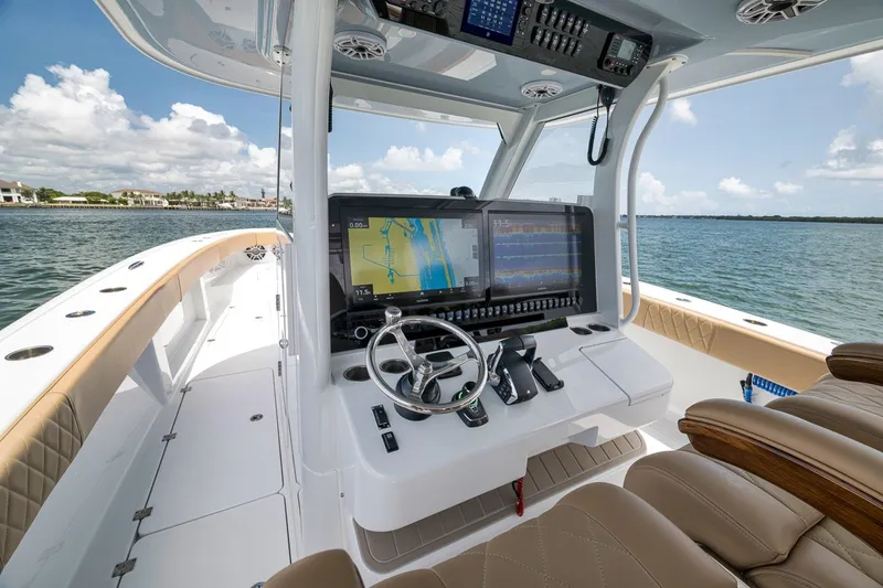 Slide: The Image of Luxurious 2026 Freeman 42LR boat cockpit with advanced navigation system on open water. - 104