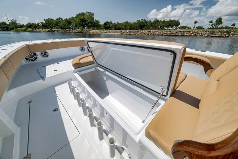 Slide: The Image of Luxurious 2026 Freeman 42LR boat interior with open storage, beige seating, and scenic water view. - 51