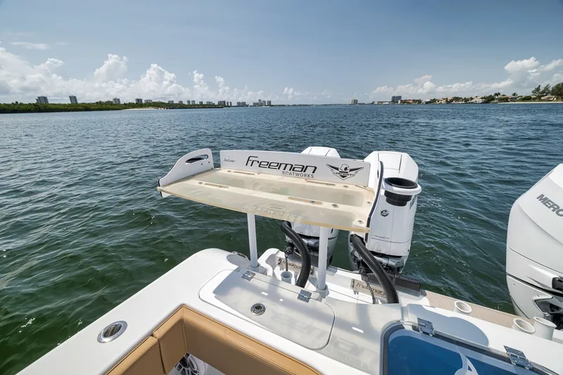 Slide: The Image of Freeman 42LR boat on water, showcasing dual Mercury engines, 2026 model. - 60