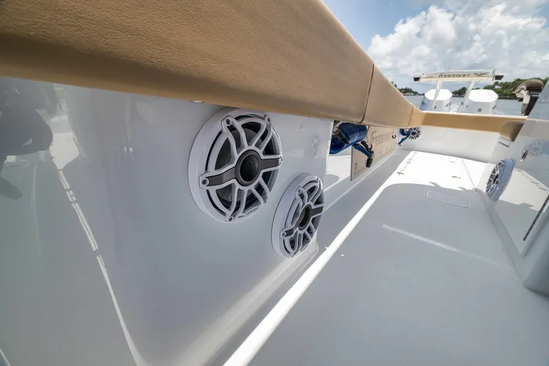 Slide: The Image of 2026 Freeman 42LR boat interior with speakers and cushioned seating under a clear sky. - 118