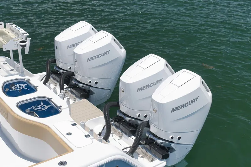 Slide: The Image of Four Mercury outboard engines on a 2026 Freeman 42LR boat in water. - 28