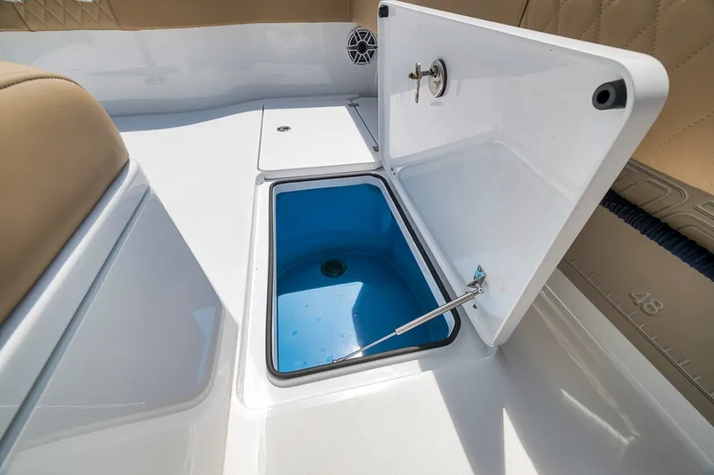 Slide: The Image of Open storage compartment on 2026 Freeman 42LR boat with blue interior. - 70