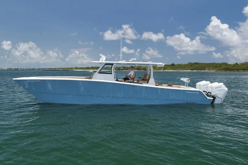 Slide: The Image of A 2026 Freeman 42LR boat on calm waters under a partly cloudy sky. - 29