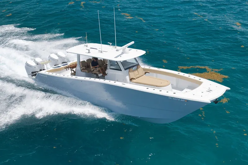 The Image of 2026 Freeman 42LR boat cruising on clear blue ocean waters. - 1