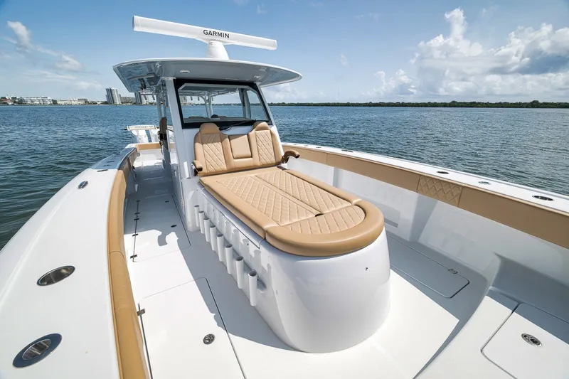 Slide: The Image of 2026 Freeman 42LR luxury boat with tan seating, cruising on calm waters. - 58