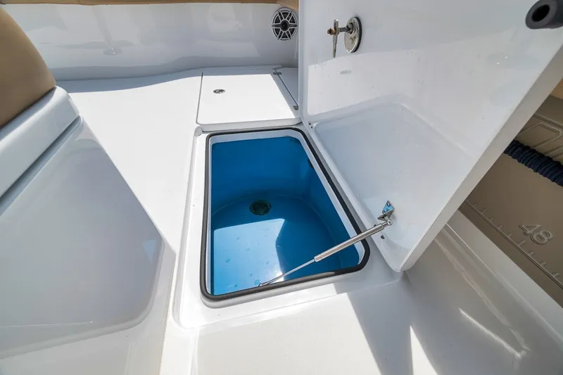 Slide: The Image of Open storage compartment on a 2026 Freeman 42LR boat, featuring a blue interior. - 69