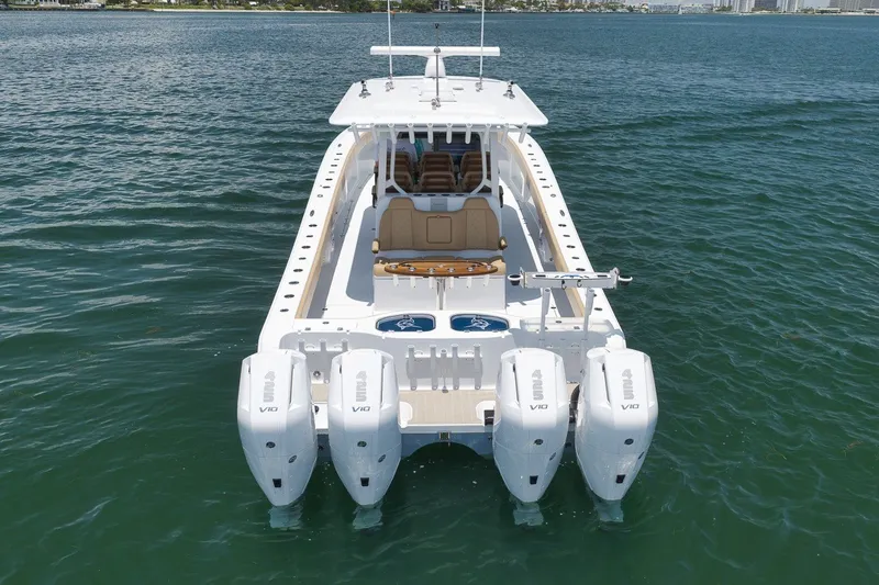 Slide: The Image of Freeman 42LR 2026 boat with four powerful outboard engines on open water. - 24