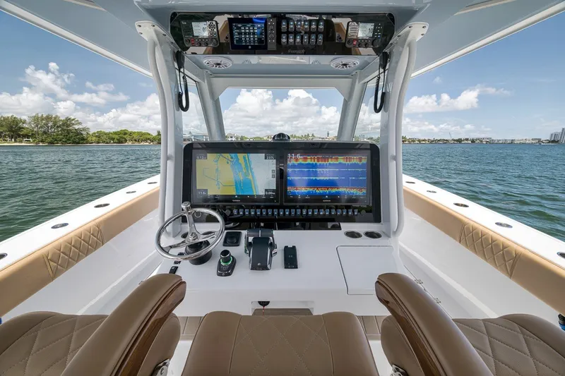 Slide: The Image of Modern helm of 2026 Freeman 42LR boat with advanced navigation displays on open water. - 106