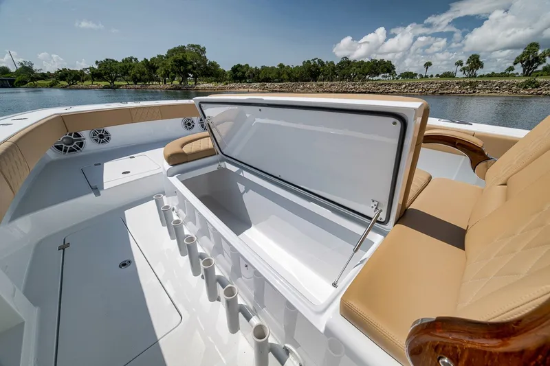 Slide: The Image of Luxurious Freeman 42LR 2026 boat interior with seating and storage, set against a scenic water backdrop. - 50