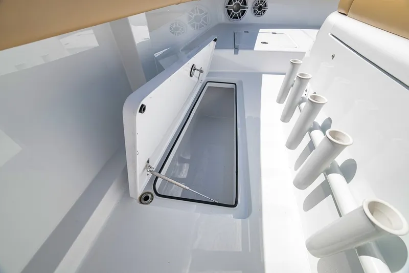 Slide: The Image of Freeman 42LR 2026 boat interior with storage compartment and rod holders. - 44