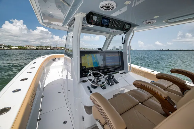 Slide: The Image of Modern Freeman 42LR boat cockpit with advanced navigation system, luxurious seating, and ocean view. - 105