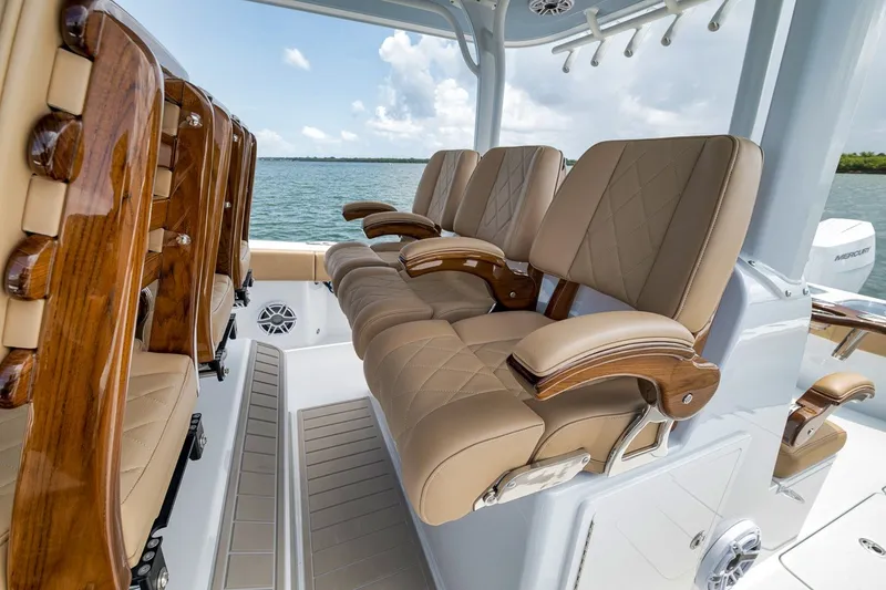 Slide: The Image of Luxurious seating on 2026 Freeman 42LR boat, featuring elegant wood and leather design. - 99