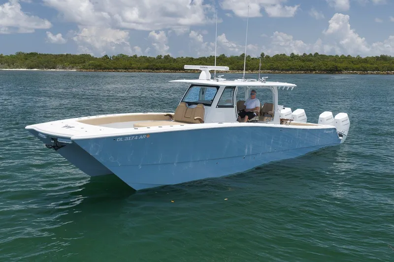 Slide: The Image of 2026 Freeman 42LR boat on water, clear sky, lush shoreline in background. - 31