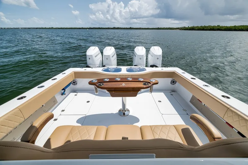 Slide: The Image of Luxury Freeman 42LR boat deck with seating and four engines, 2026 model, on open water. - 72