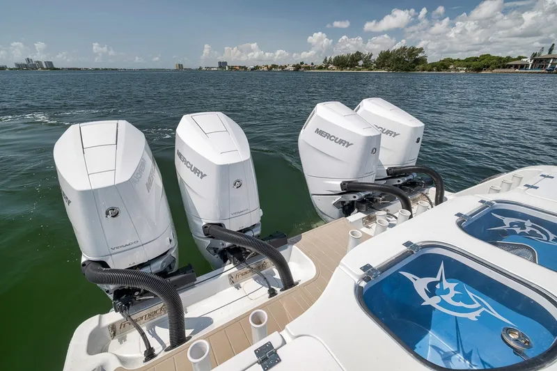 Slide: The Image of Freeman 42LR 2026 boat with four Mercury outboard engines on a sunny day. - 62