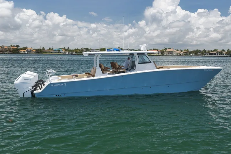 Slide: The Image of 2026 Freeman 42LR boat on water, featuring sleek design and twin Mercury engines. - 21