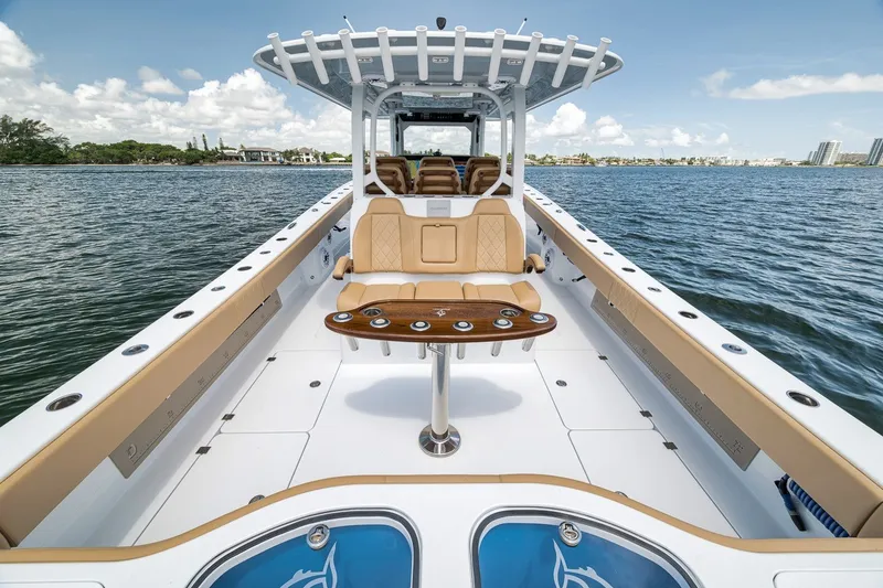 Slide: The Image of Freeman 42LR 2026 boat interior with seating and table on calm water. - 83