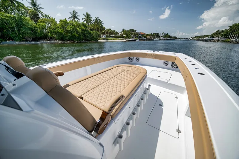 Slide: The Image of Luxurious 2026 Freeman 42LR boat interior with tan seating, cruising on a scenic waterway. - 35