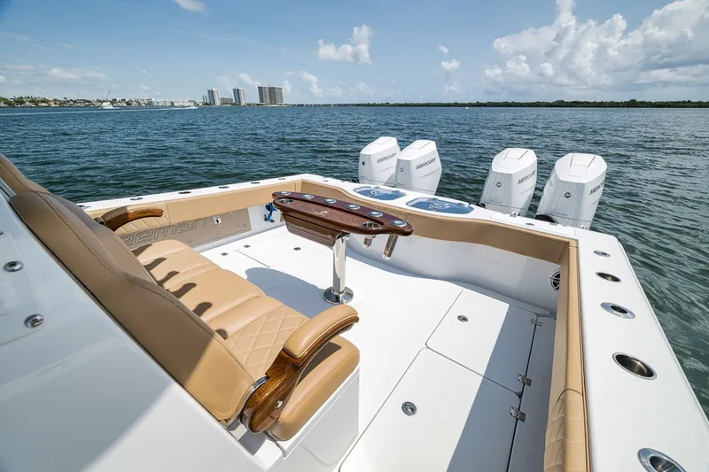 Slide: The Image of Luxurious 2026 Freeman 42LR boat with tan seating and multiple outboard engines on open water. - 75