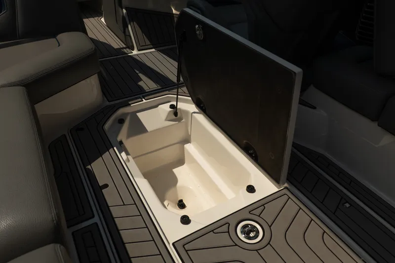 Slide: The Image of 2019 Nautique Super Air Nautique G23 storage compartment with open lid, showcasing interior space. - 30