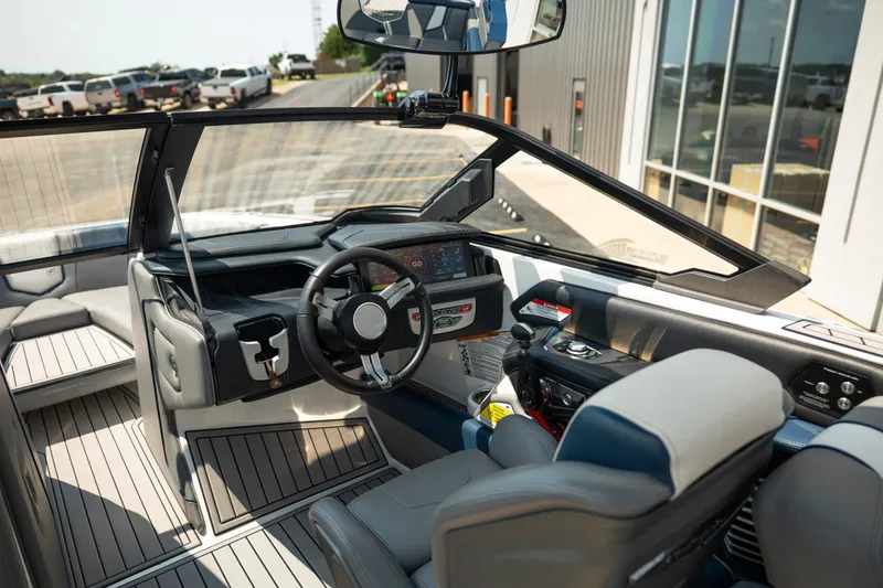 Slide: The Image of 2019 Nautique Super Air Nautique G23 boat interior with modern dashboard and steering wheel. - 31