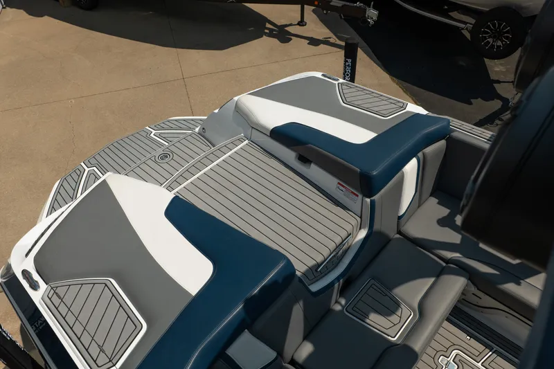 Slide: The Image of 2019 Nautique Super Air Nautique G23 boat interior with gray and blue seating. - 19