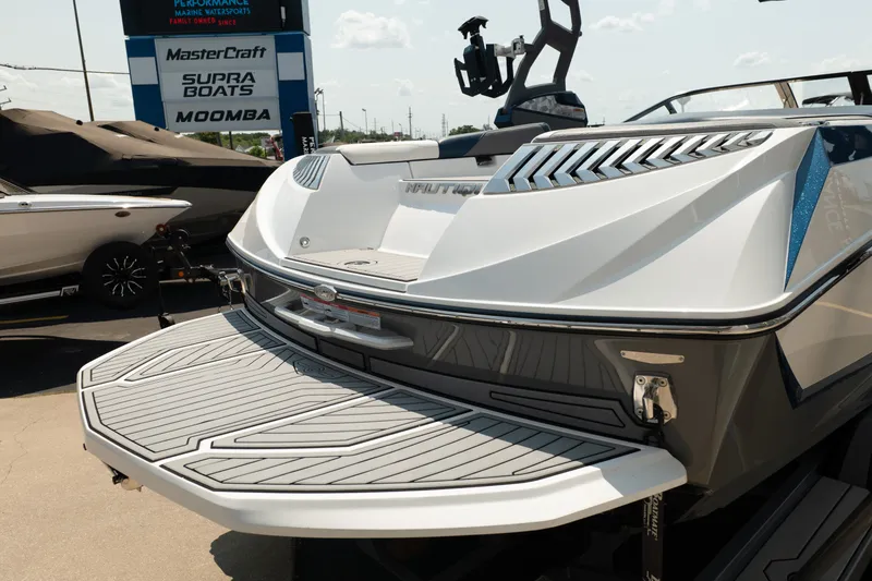 Slide: The Image of 2019 Nautique Super Air Nautique G23 boat at dealership, showcasing rear deck and branding. - 9