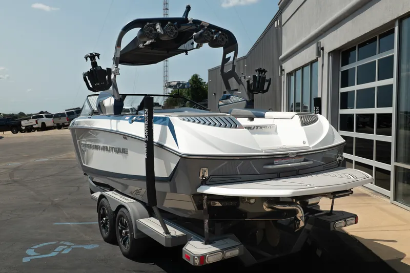 Slide: The Image of 2019 Nautique Super Air Nautique G23 boat on trailer near garage. - 5