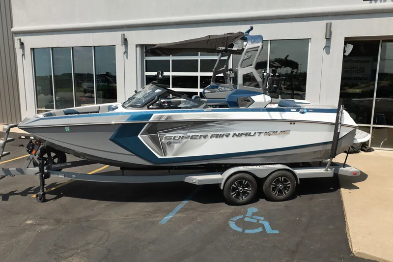 Slide: The Image of 2019 Nautique Super Air Nautique G23 boat on trailer, parked outside a building. - 4