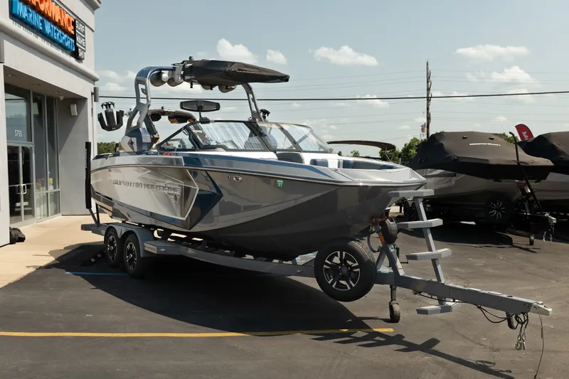 Slide: The Image of 2019 Nautique Super Air Nautique G23 boat on trailer outside marine dealership. - 12