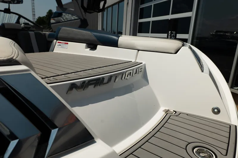 Slide: The Image of 2019 Nautique Super Air Nautique G23 boat, rear deck view with logo detail. - 16